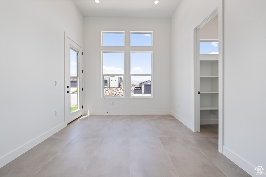Spare room with concrete flooring, baseboards, and recessed lighting