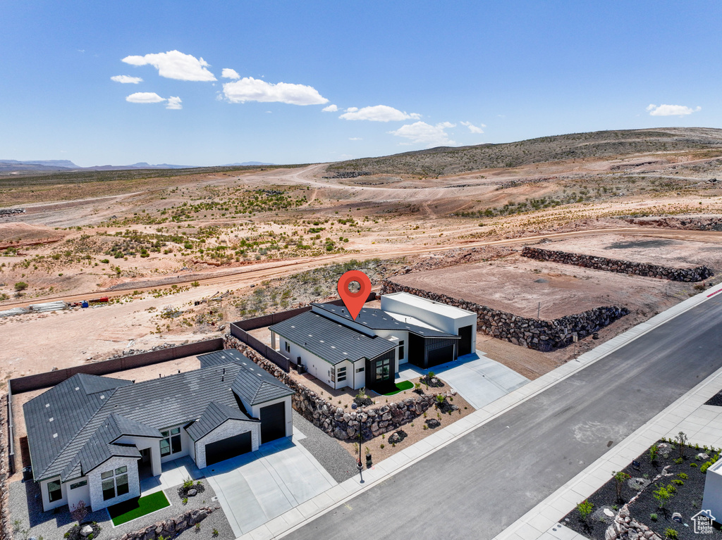 Aerial view of sparsely populated area with a desert landscape and a mountainous background