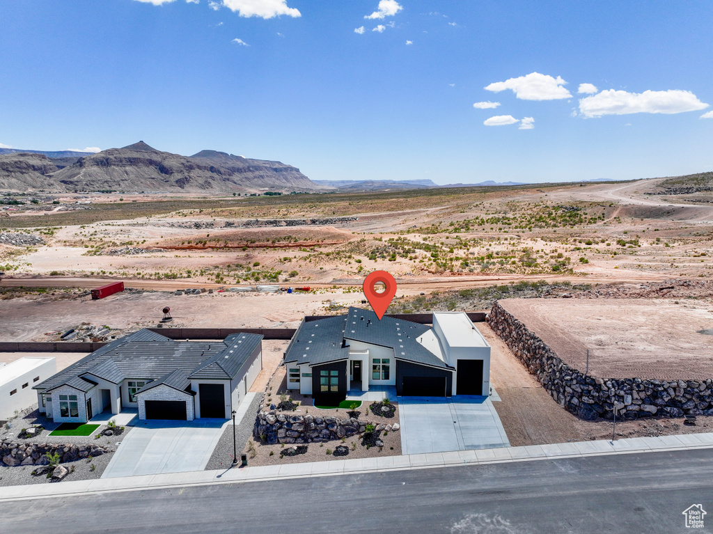View of rural area featuring a mountain backdrop and a desert landscape