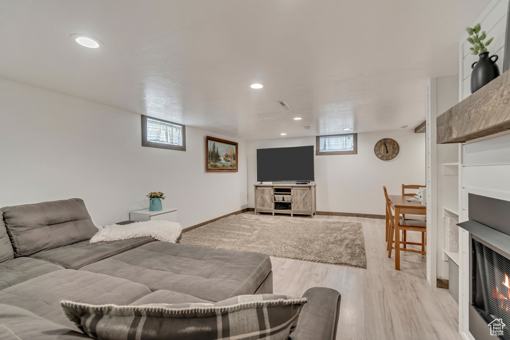 Living area featuring recessed lighting, light wood-style flooring, and baseboards