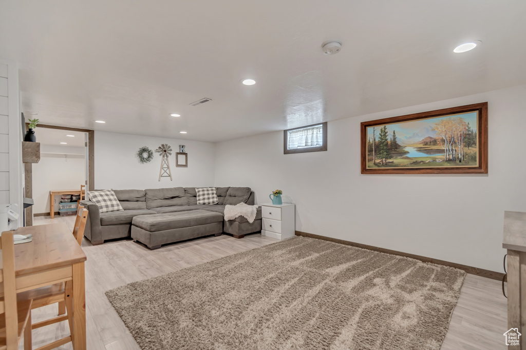Living area featuring light wood finished floors, recessed lighting, and baseboards