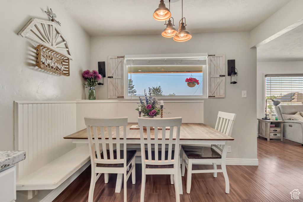 Dining area featuring plenty of natural light, wood finished floors, and baseboards