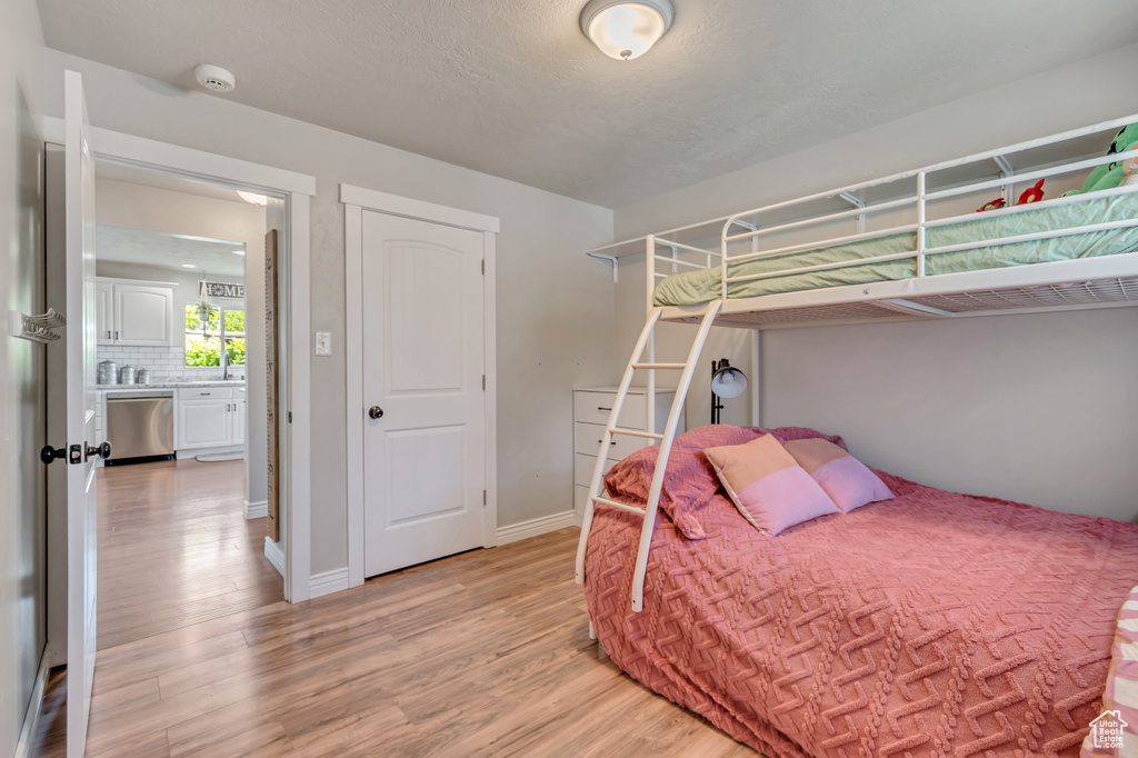 Bedroom featuring light wood finished floors and baseboards