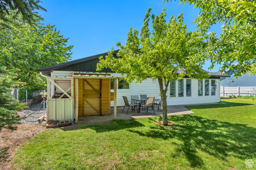 Back of property with board and batten siding and a patio area