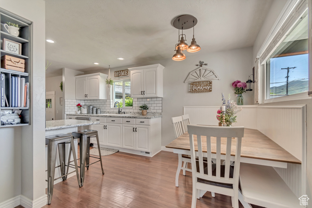 Dining room featuring light wood-style flooring and recessed lighting