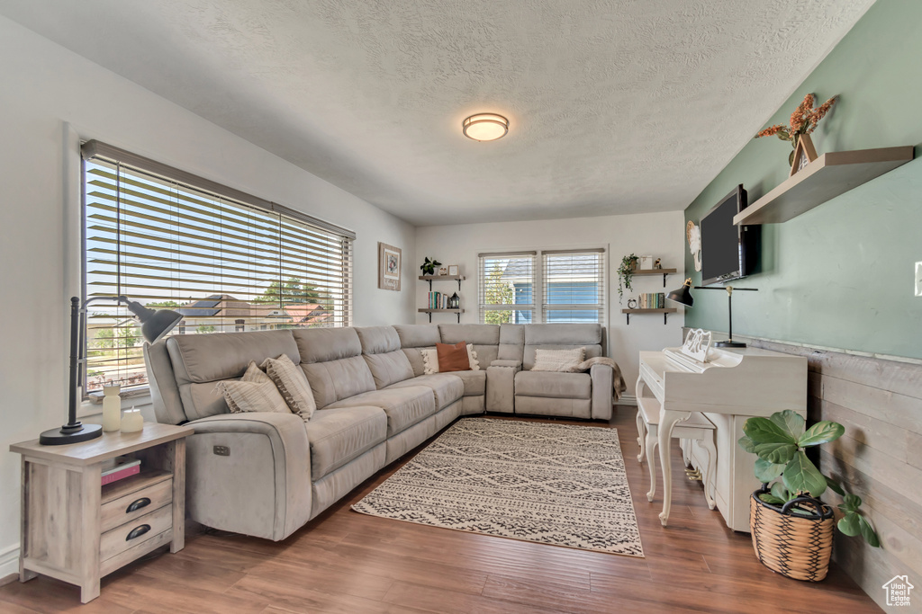 Living area with a textured ceiling and wood finished floors
