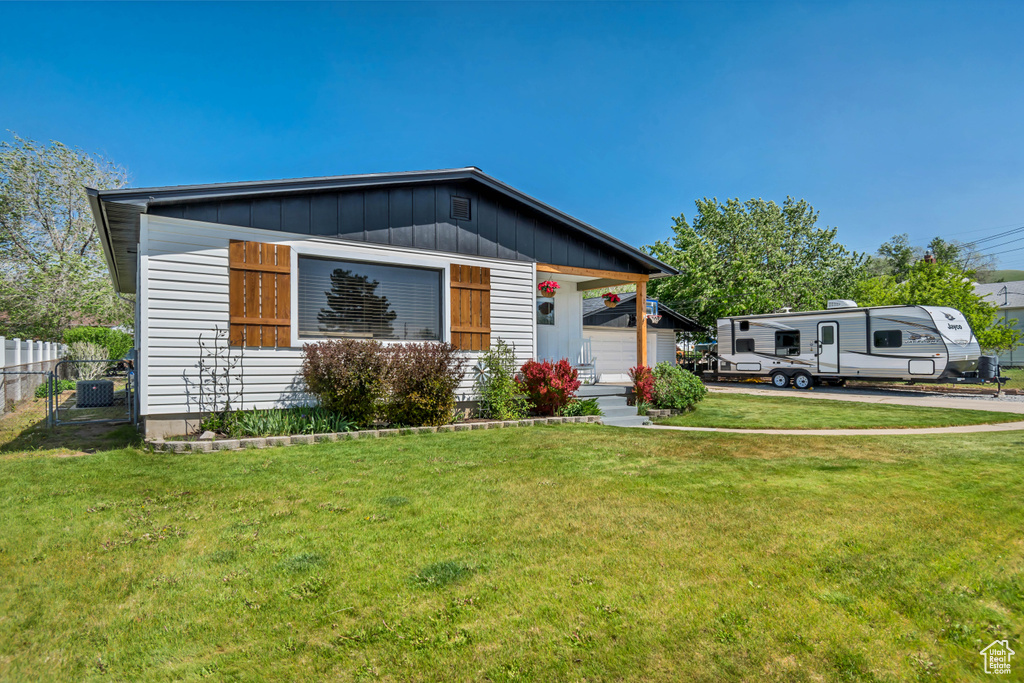 View of front of house featuring a porch and cooling unit