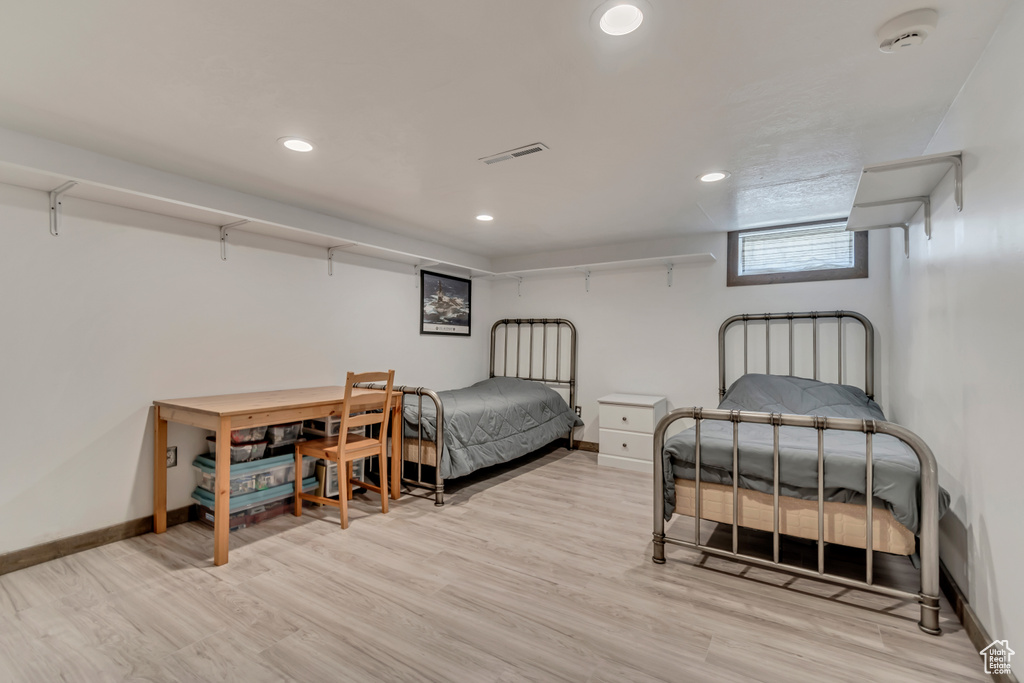 Bedroom with baseboards, recessed lighting, and light wood-style floors
