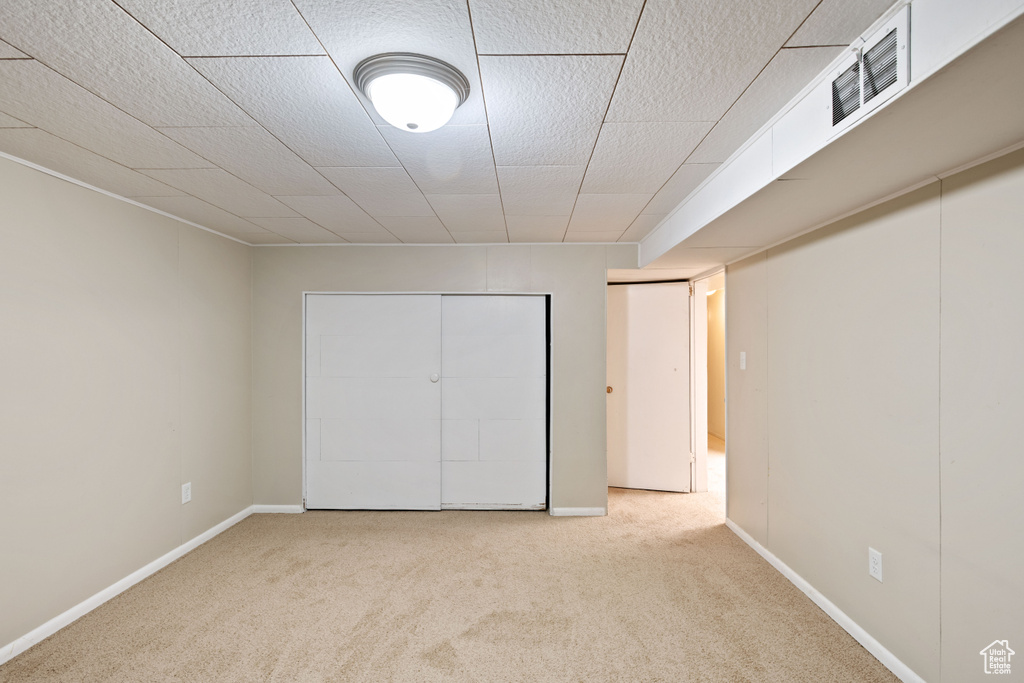 Unfurnished bedroom featuring carpet and baseboards