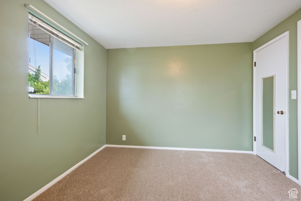 Empty room with carpet flooring and baseboards