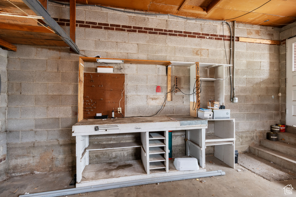 Unfinished basement featuring a workshop area