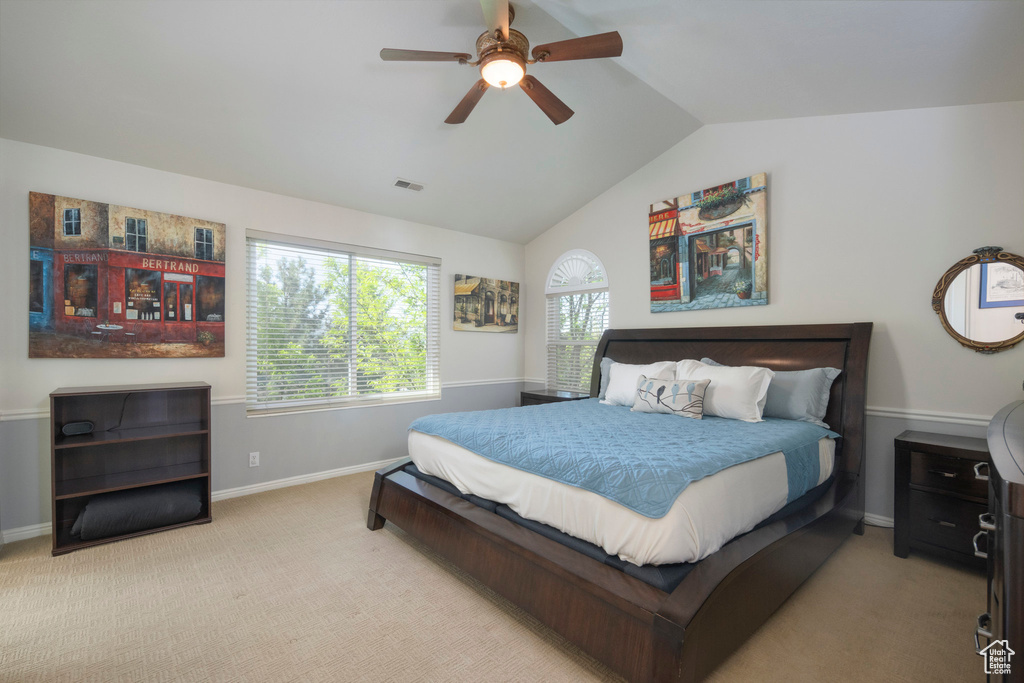 Bedroom featuring vaulted ceiling, baseboards, carpet flooring, and a ceiling fan