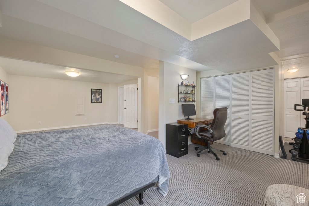 Bedroom featuring carpet floors, baseboards, and an office area