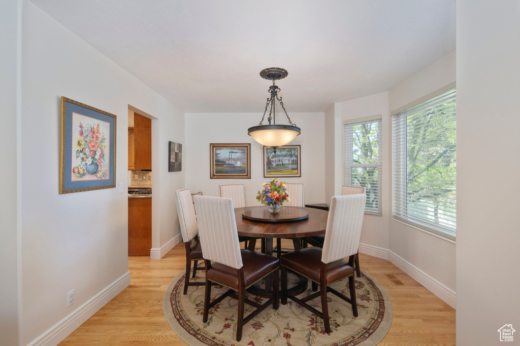 Dining area with light wood-type flooring and baseboards