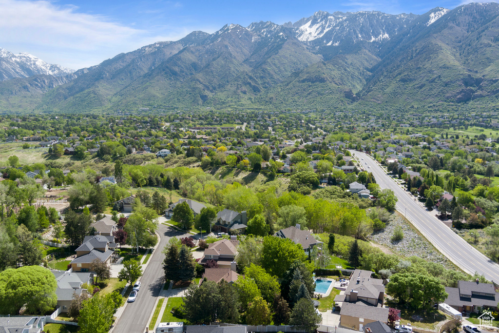 Aerial view of residential area featuring a mountainous background