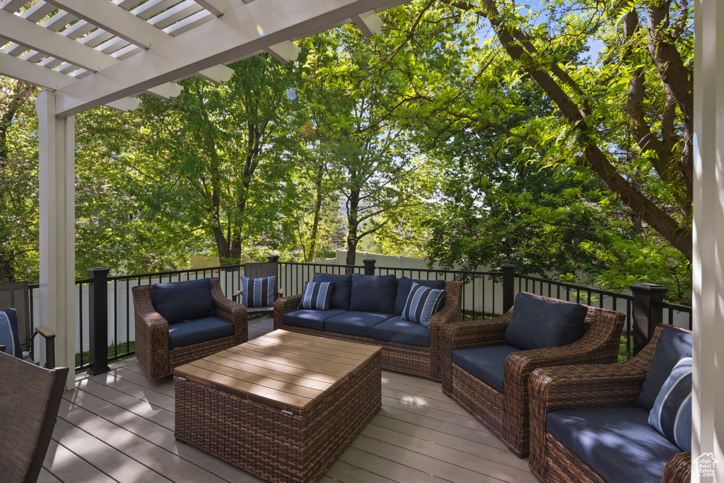 Wooden deck featuring outdoor lounge area and a pergola