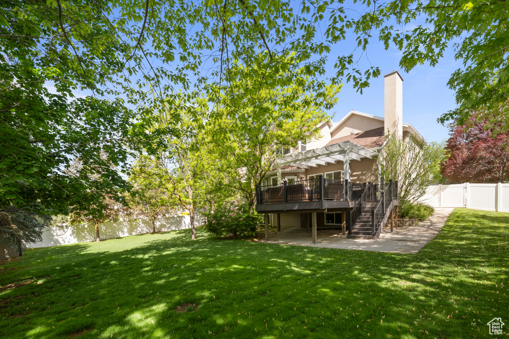 View of yard with a pergola, stairway, a patio area, and a deck