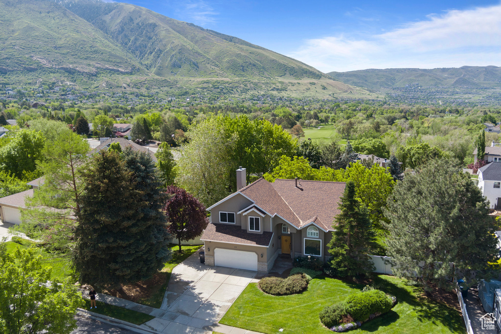 View of subject property featuring a mountainous background