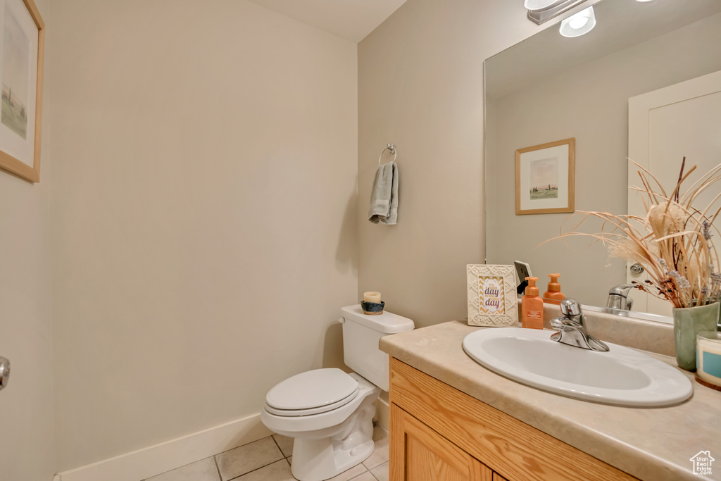 Bathroom featuring tile patterned flooring, toilet, and vanity