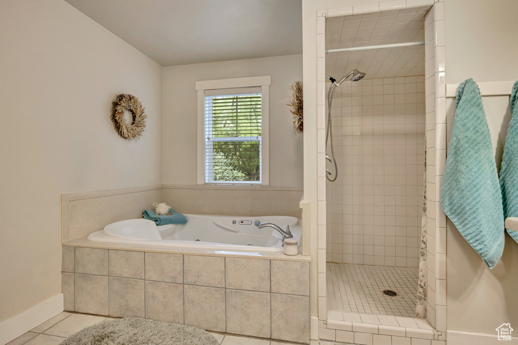 Full bath featuring tile patterned floors, a shower stall, and a garden tub