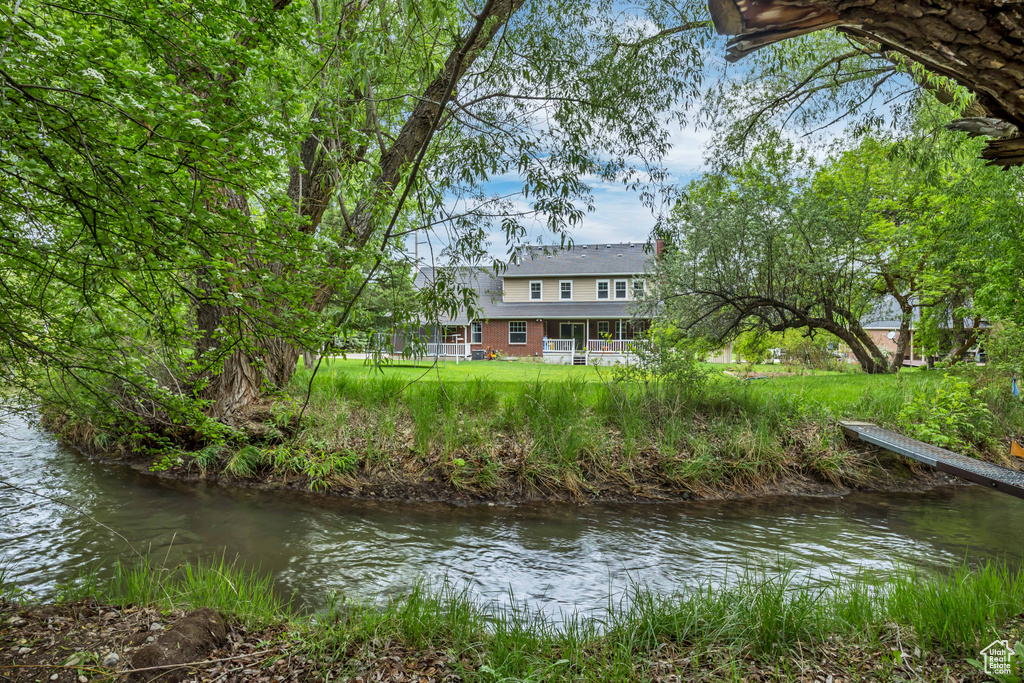 Back of property featuring a water view