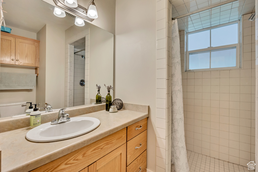 Full bathroom with a tile shower and vanity