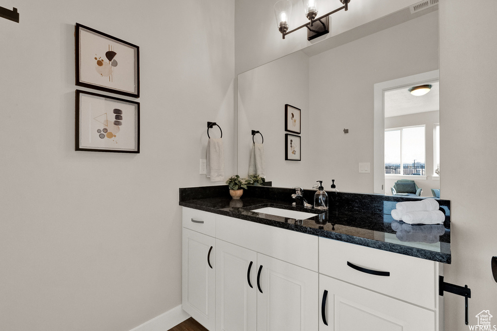 Bathroom featuring vanity and baseboards