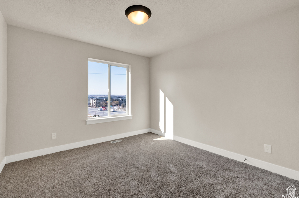 Spare room with carpet floors and baseboards