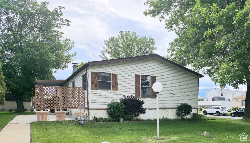 View of property exterior featuring a lawn
