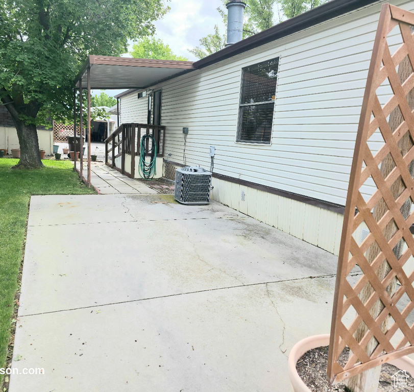 View of home\\\\\\\\\\\\\\\\\\\\\\\\\\\\\\\'s exterior featuring a patio area, central AC unit, and a lawn