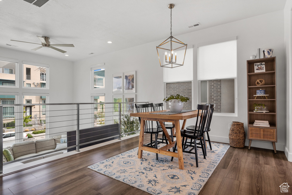 Dining room featuring a chandelier, a ceiling fan, wood finished floors, and recessed lighting