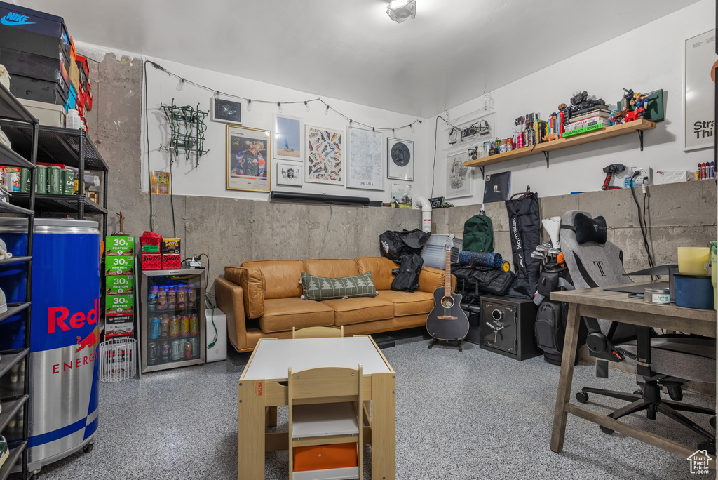 Living area featuring speckle patterned floor and an office area