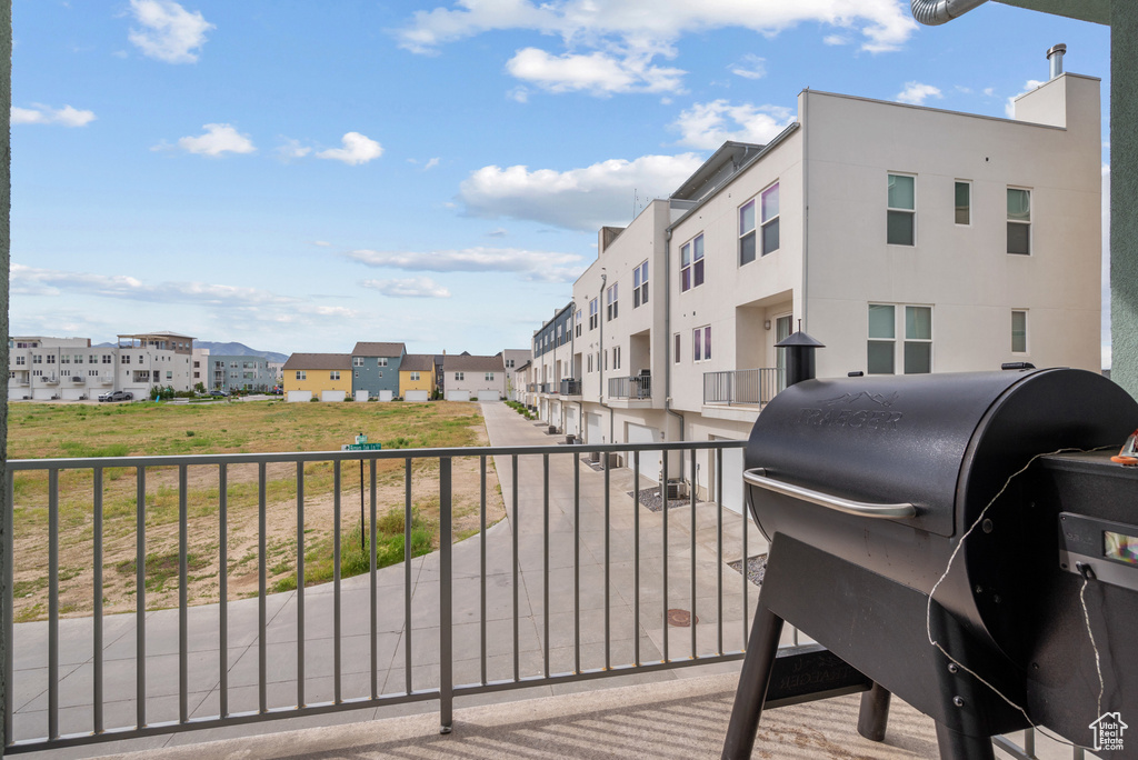 Balcony featuring grilling area and a residential view