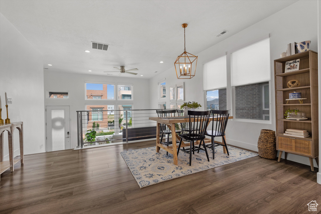 Dining area featuring wood finished floors, ceiling fan, recessed lighting, and a chandelier