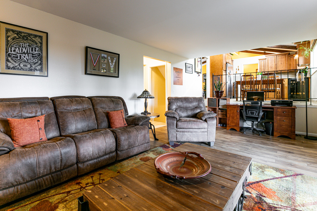 Living room with light wood-type flooring and a desk
