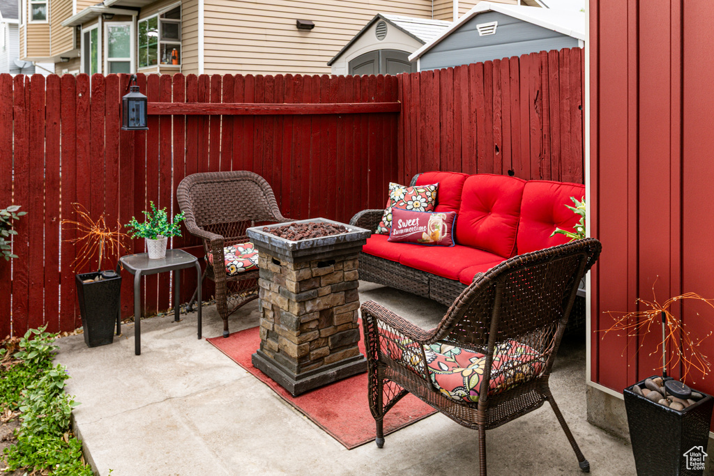 View of patio featuring outdoor lounge area and fence