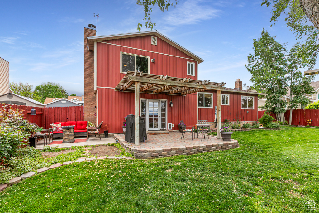 Back of house with a chimney, outdoor lounge area, a pergola, and a patio