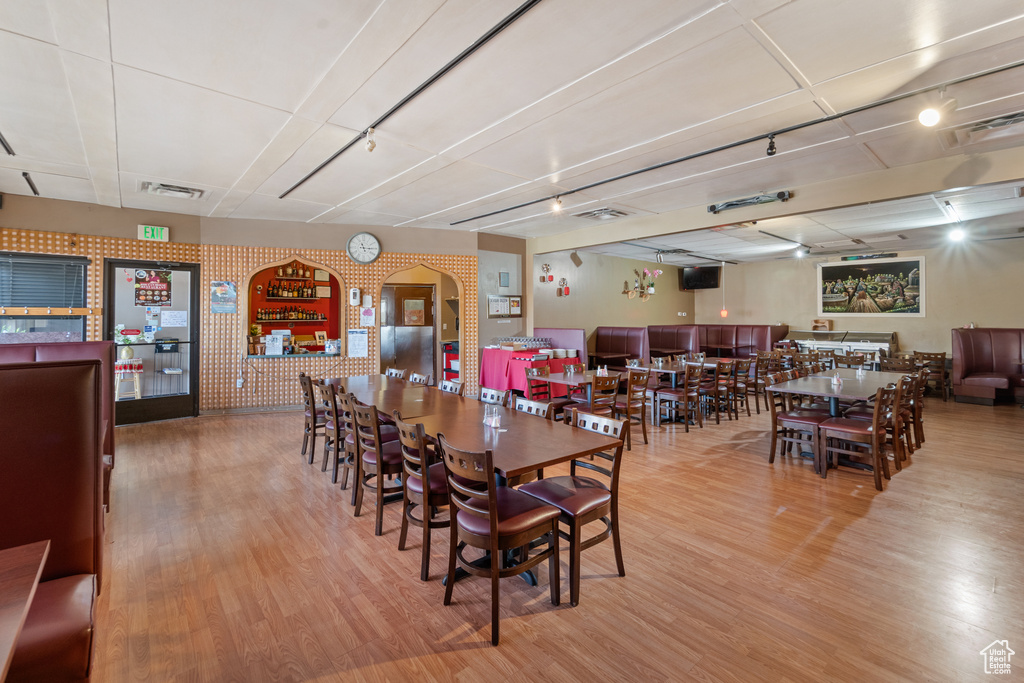 Dining area featuring wood finished floors and arched walkways