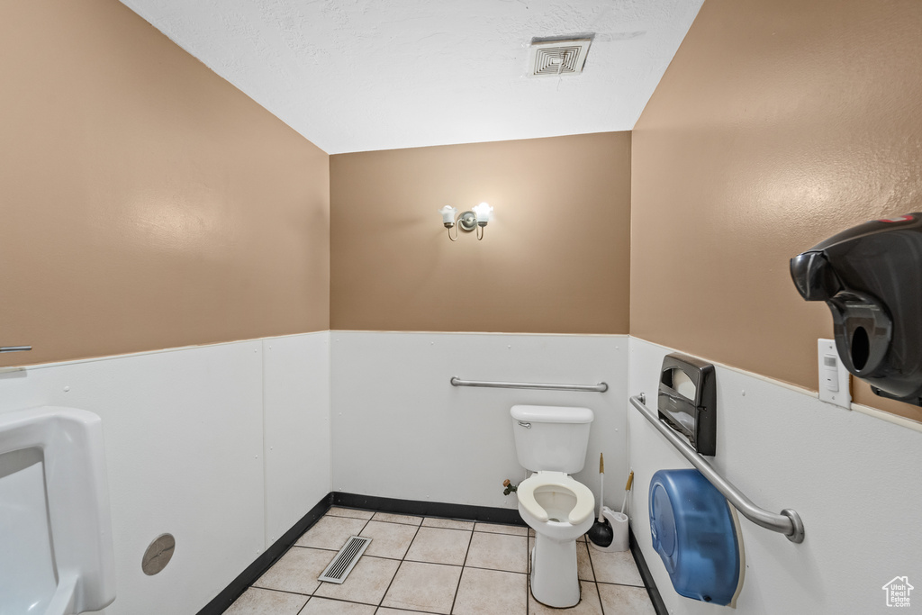 Bathroom with tile patterned floors and toilet