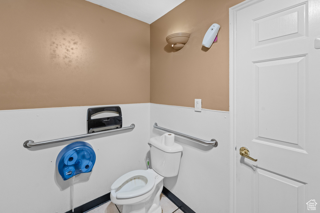Bathroom featuring toilet and tile patterned flooring