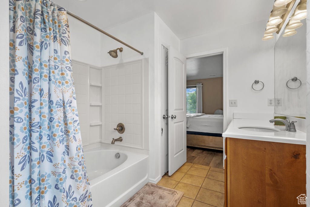 Bathroom featuring tile patterned flooring, ensuite bathroom, vanity, and shower / bath combo