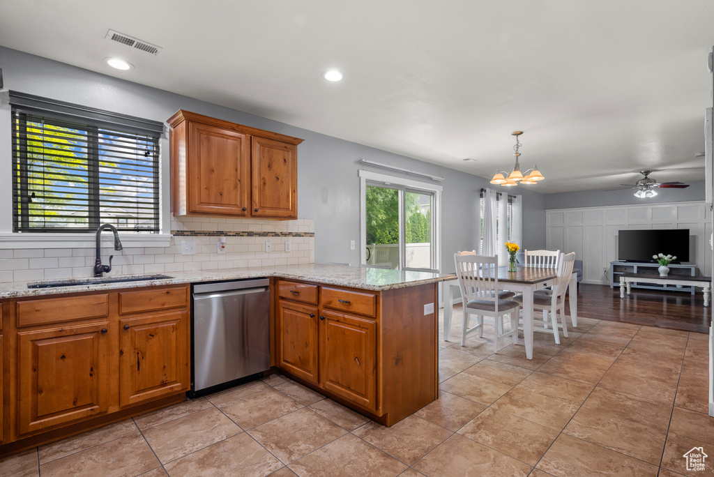 Kitchen with dishwasher, a sink, decorative backsplash, a peninsula, and ceiling fan