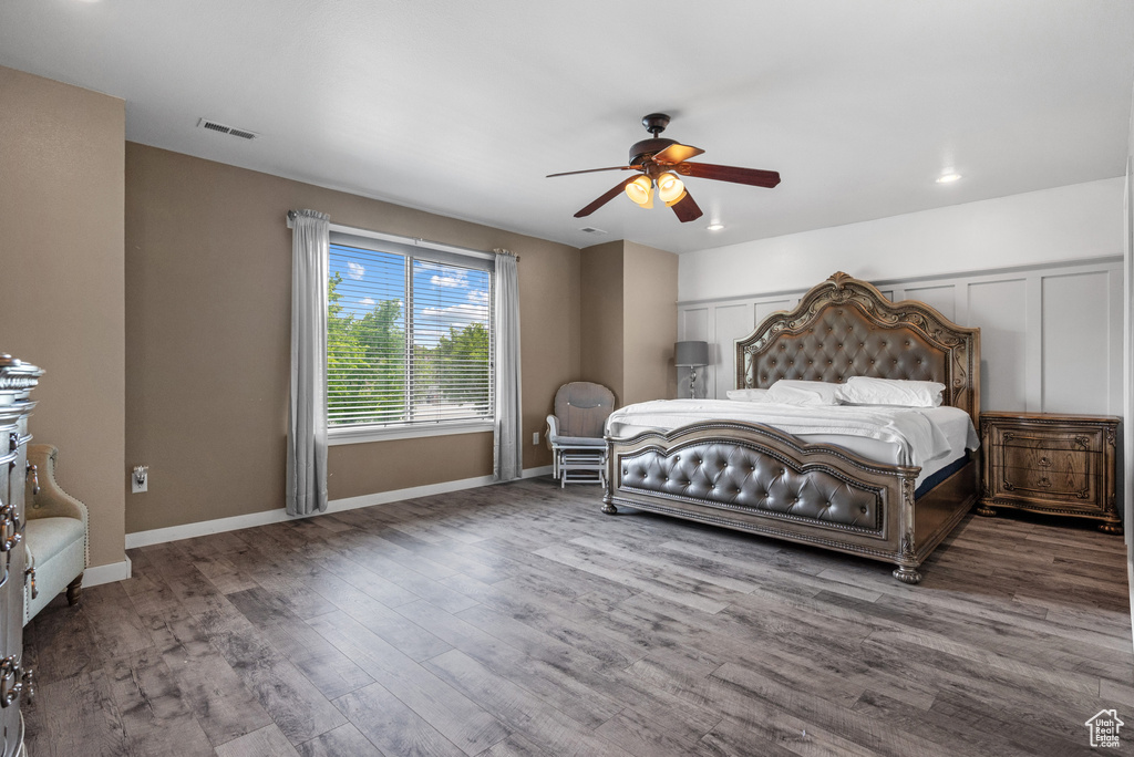 Bedroom featuring wood finished floors, a ceiling fan, and baseboards
