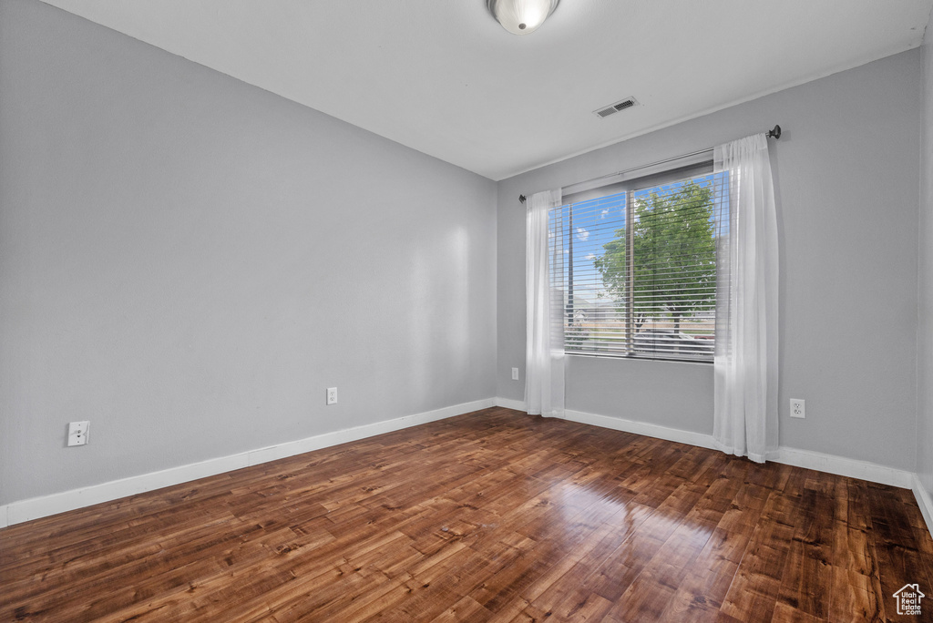 Spare room with wood finished floors and baseboards