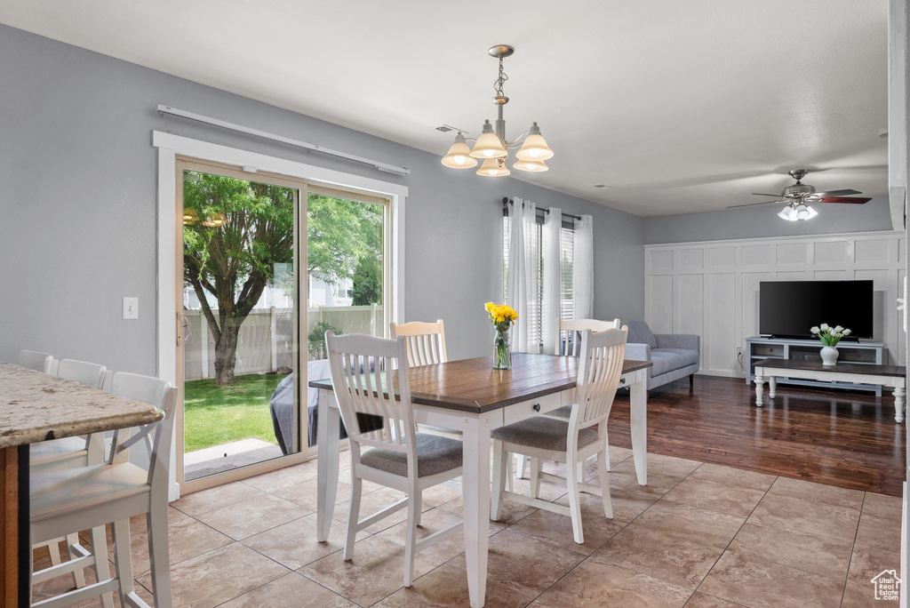 Dining area featuring a chandelier, ceiling fan, and light tile patterned floors