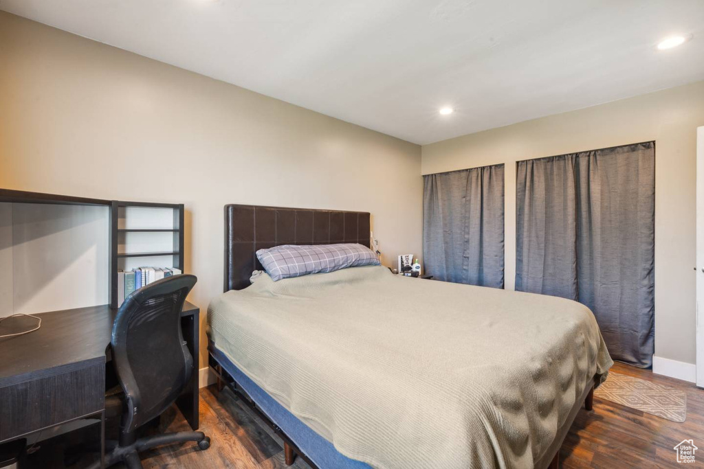 Bedroom featuring wood finished floors, baseboards, recessed lighting, and an office area