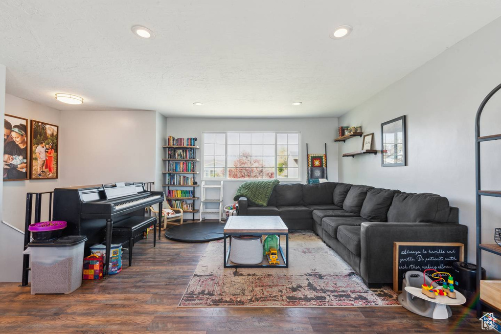 Living area with wood finished floors and recessed lighting