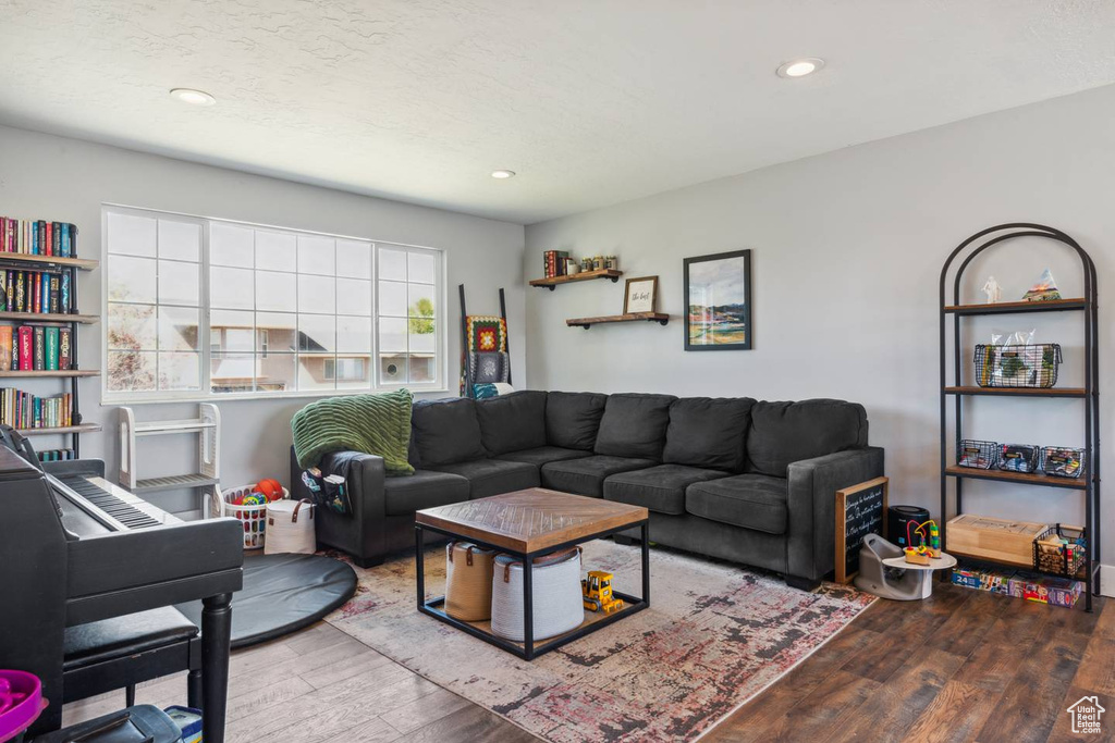 Living area featuring wood finished floors and recessed lighting