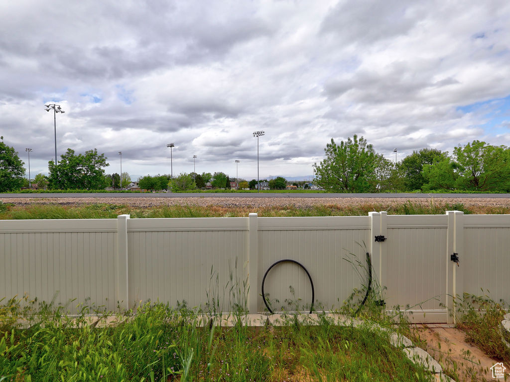 View of yard with fence and a gate