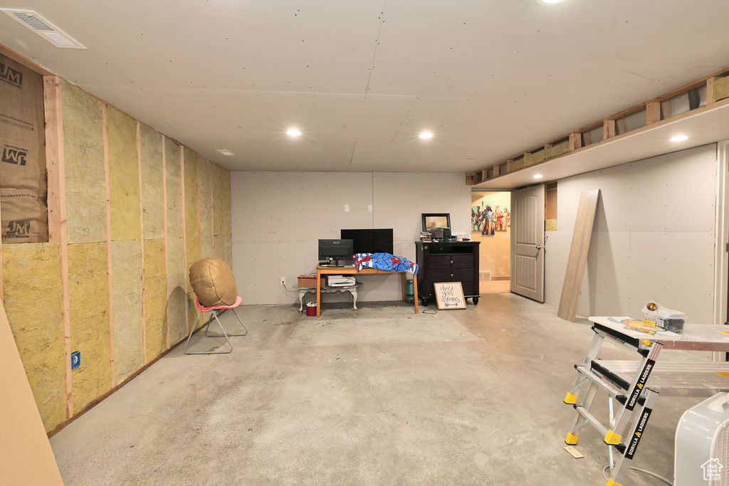 Finished basement featuring recessed lighting and an office area